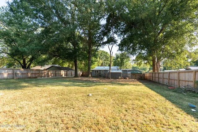 a view of swimming pool and trees in the background