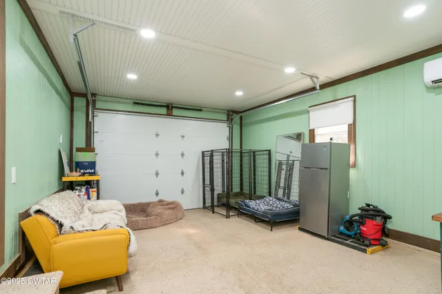 a bedroom with furniture and a large window