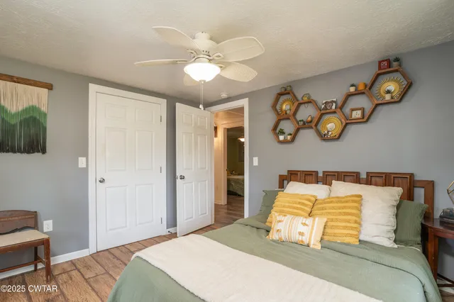 a bedroom with a bed and a chandelier