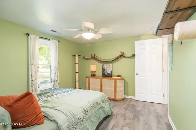 a bedroom with a bed mirror and a window