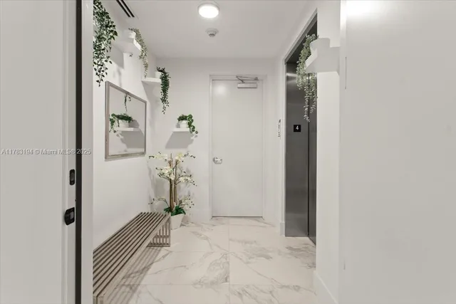 a view of a hallway with paintings on the wall