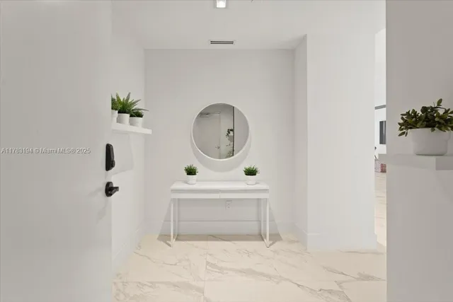 a view of a room with wooden floor and mirror