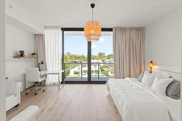 a bedroom with a bed and a chandelier