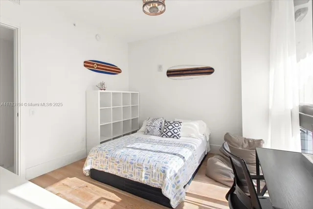 a bedroom with a bed and a dresser