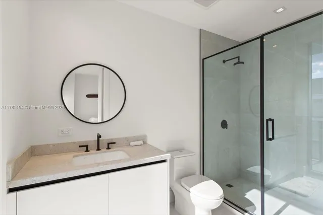 a bedroom with a bed a mirror and a window