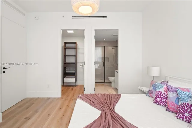 a bedroom with a bed and a view of bathroom