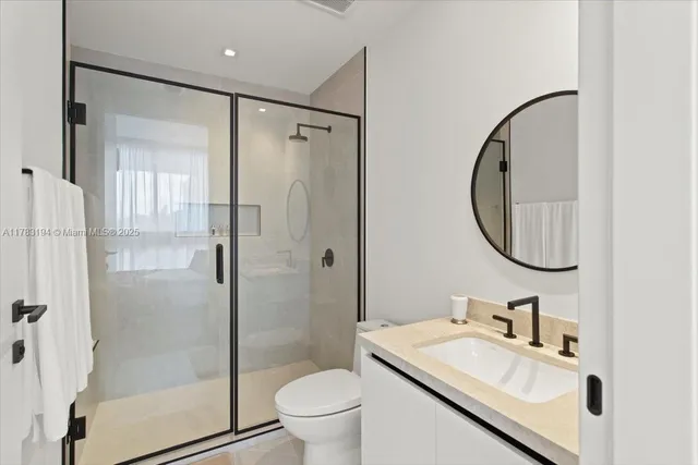 a bathroom with a sink toilet and shower