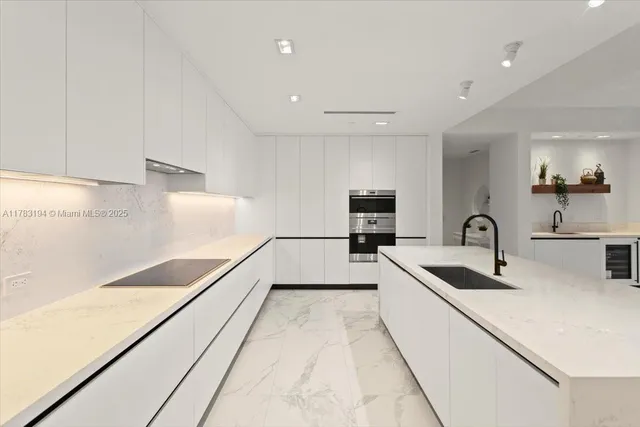 a kitchen with a sink and white cabinets