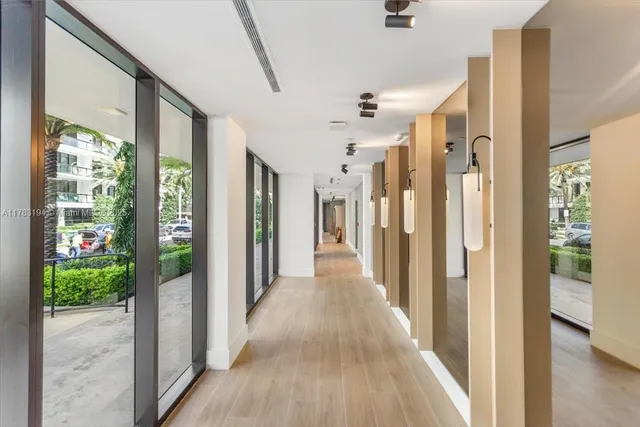 a view of a hallway with wooden floor and doors