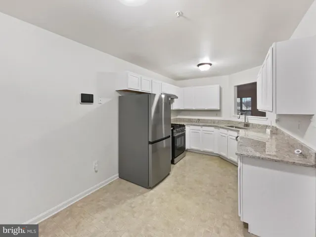 a kitchen with a refrigerator sink and microwave