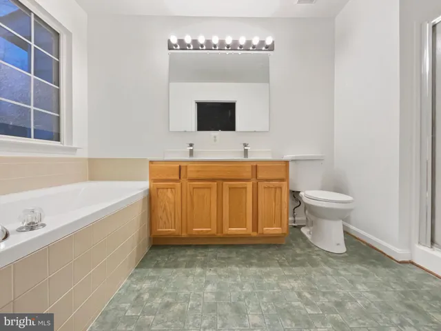 a bathroom with a sink a toilet and bathtub