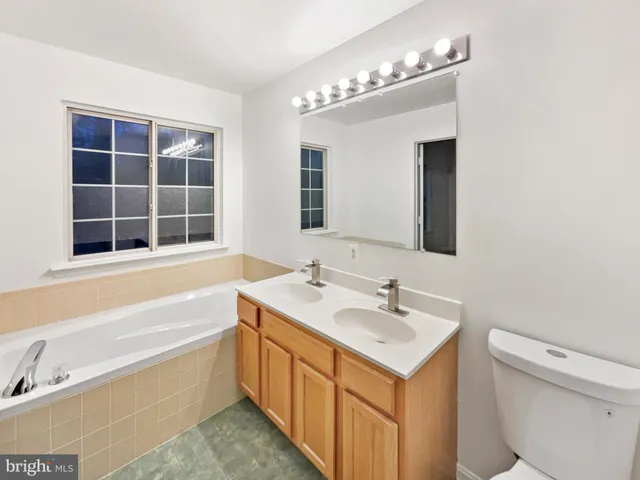 a bathroom with a sink a large mirror and a bathtub