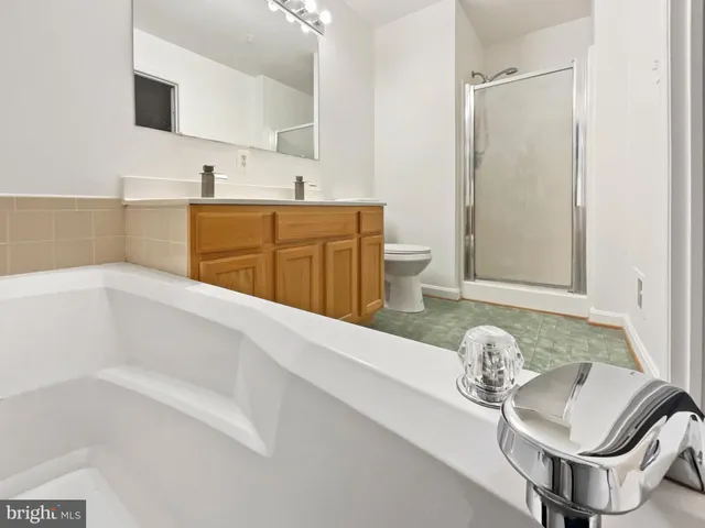 a bathroom with a tub sink and mirror