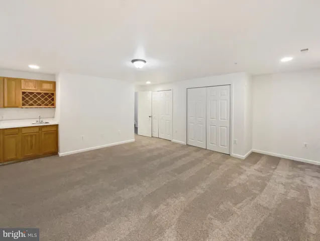 a view of an empty room with a kitchen