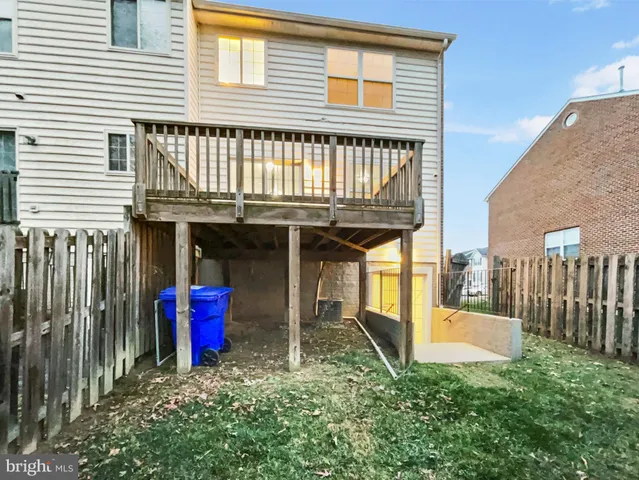 a view of a house with large windows and a small yard