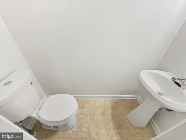 a white toilet sitting next to a bathroom sink