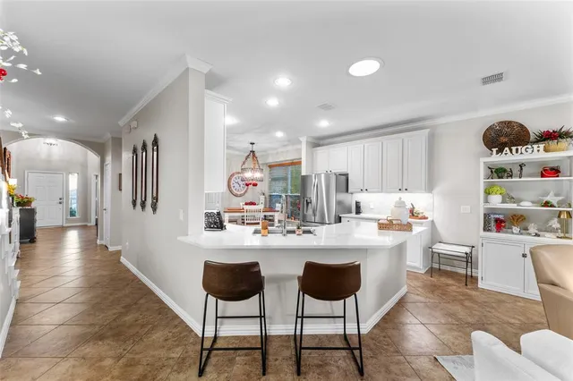 a kitchen with stainless steel appliances kitchen island granite countertop a sink and cabinets