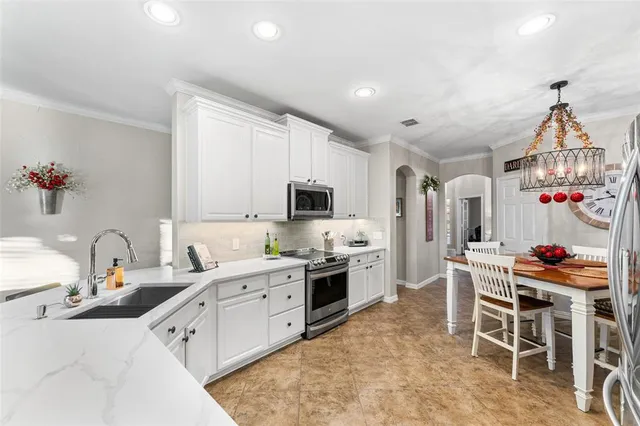 a kitchen with stainless steel appliances kitchen island granite countertop a sink and cabinets
