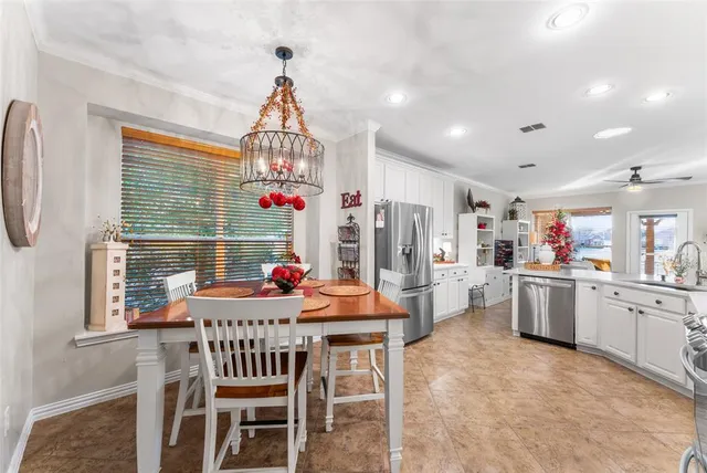 a dining room with furniture window and wooden floor