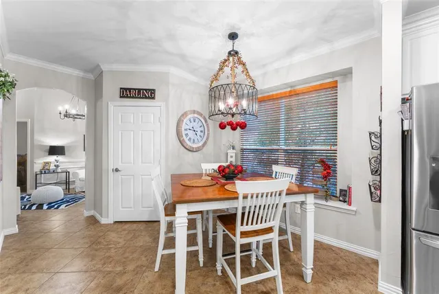 a dining room with furniture and window