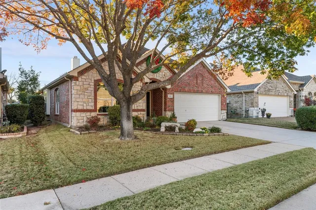 a front view of house with yard and trees around