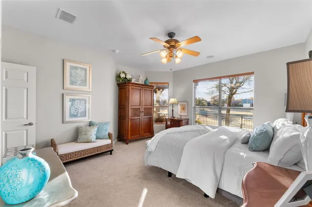 a bedroom with a bed couch and window