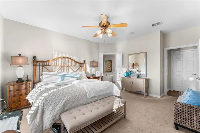a bedroom with bed and a chandelier