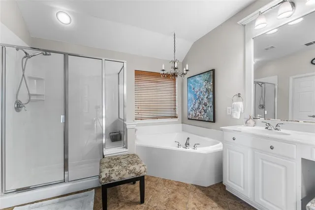 a bathroom with a tub sink and mirror