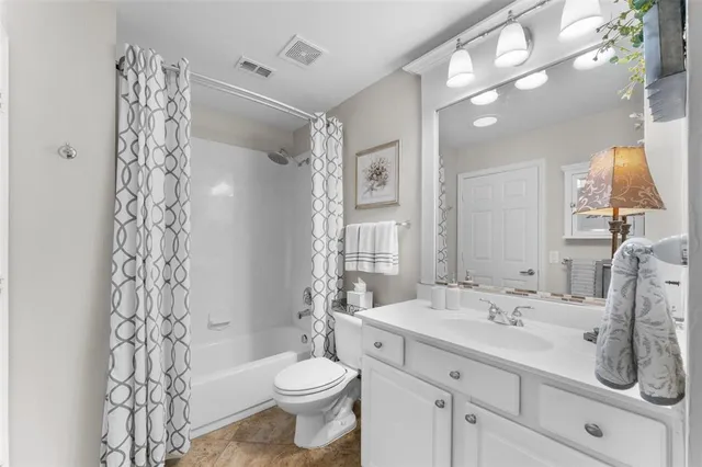 a bathroom with a double vanity sink toilet and shower