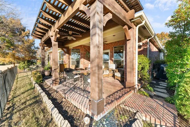 a view of a house with backyard and sitting area