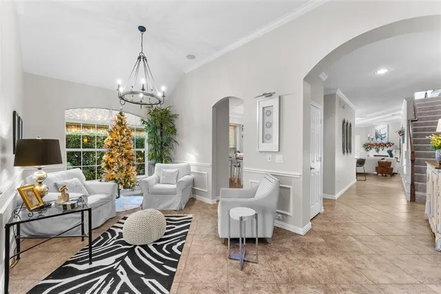 a living room with furniture and a chandelier