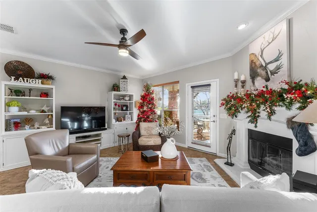a living room with furniture a fireplace and a flat screen tv