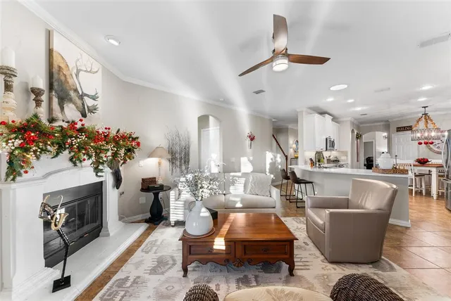 a living room with furniture a chandelier and a fireplace