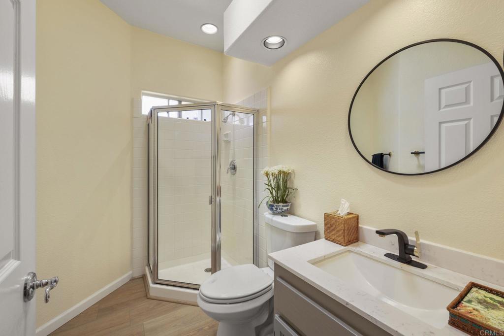 4939 Tilos Way Oceanside, CA 92056 - Photo 26 of 49 a bathroom with a sink a toilet and a mirror
