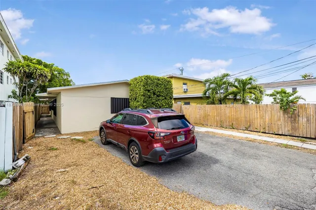 a kitchen with granite countertop a stove top oven a sink dishwasher and a refrigerator