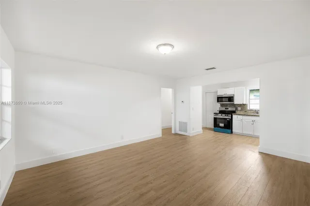 a kitchen with stainless steel appliances a stove a sink and a microwave