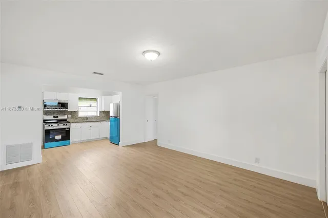 a kitchen with a refrigerator sink and microwave