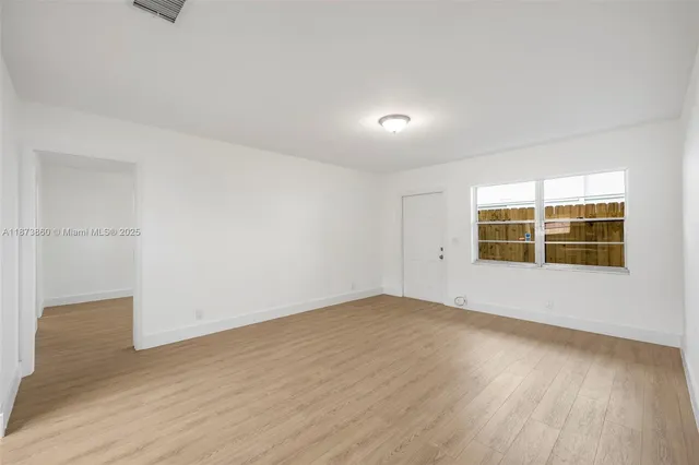 a kitchen with a refrigerator and a sink