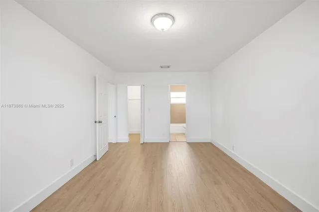 a bathroom with a granite countertop sink toilet and a mirror