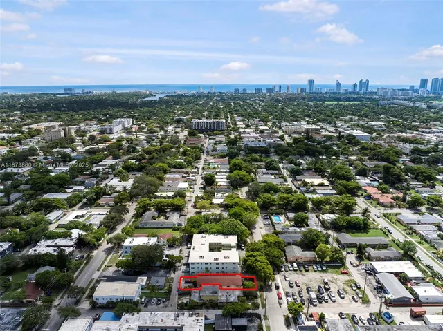 an aerial view of residential houses with city view