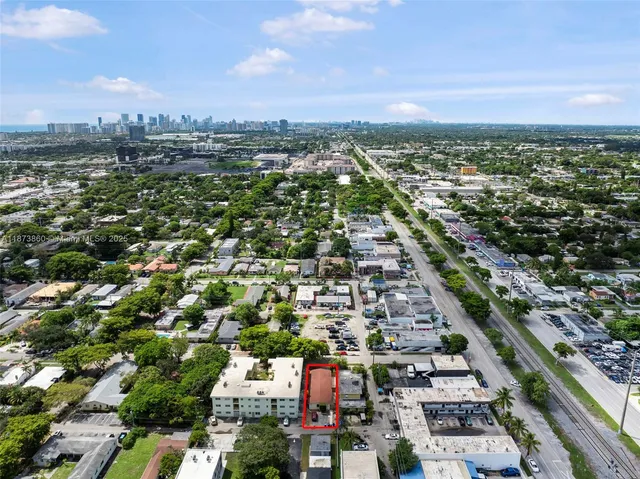 an aerial view of a house with a yard