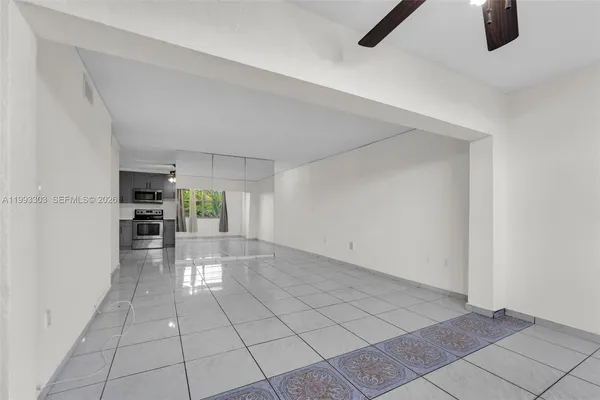 a view of hallway with furniture and a refrigerator
