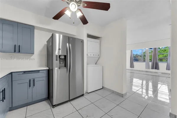 a kitchen with stainless steel appliances granite countertop a refrigerator and a cabinets