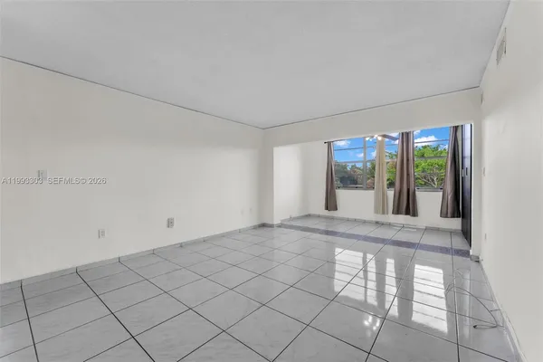 a view of an empty room with a window