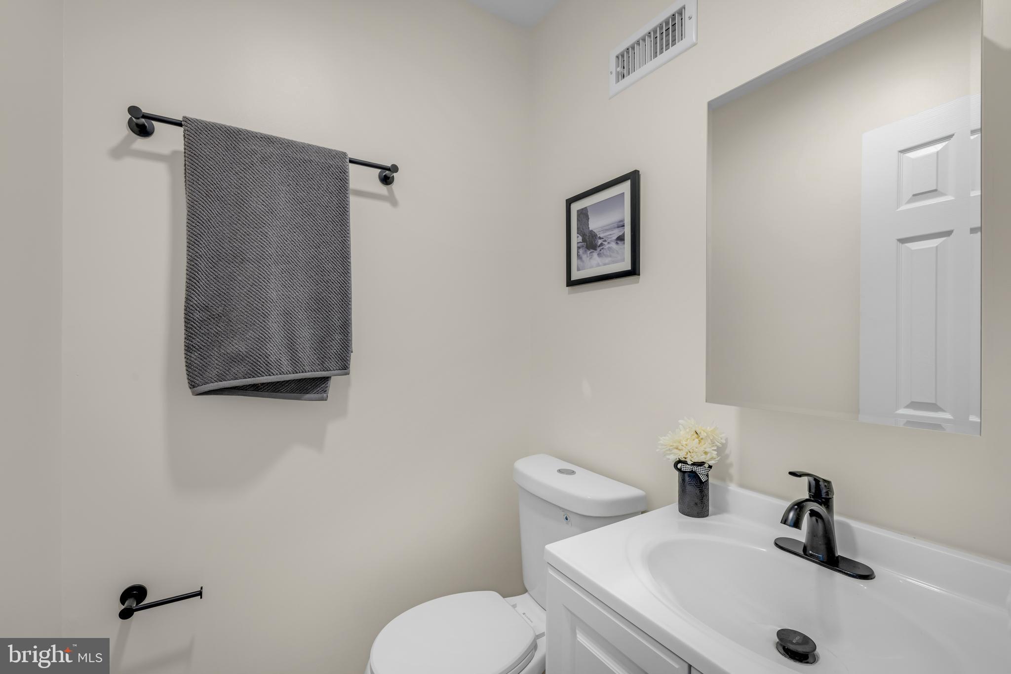 54 Valley Forge Road New Castle, DE 19720 - Photo 15 of 38 a bathroom with a toilet sink and mirror