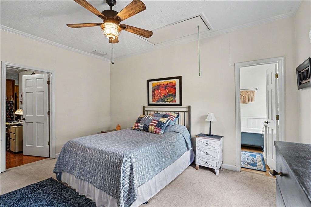 355 Inman Road Hampton, GA 30228 - Photo 28 of 47 a bedroom with a bed and a chandelier