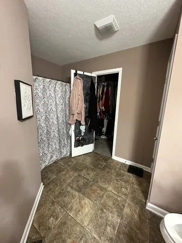 a view of a hallway with bathroom