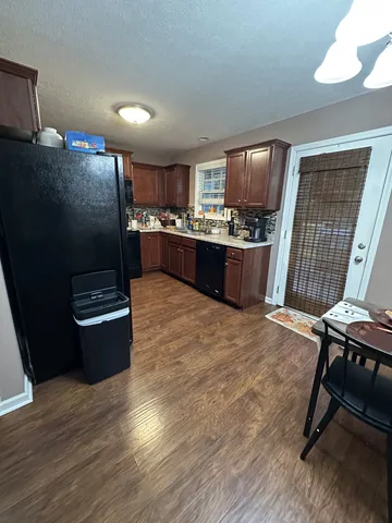 a kitchen with a refrigerator and a stove