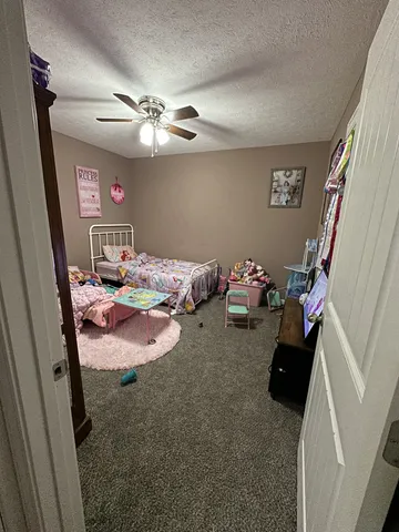 a bedroom with bed and a mirror