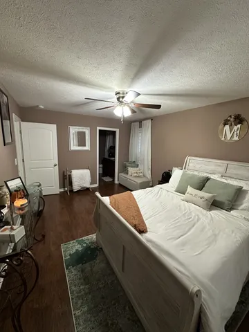 a bed room with a bed window and a chandelier